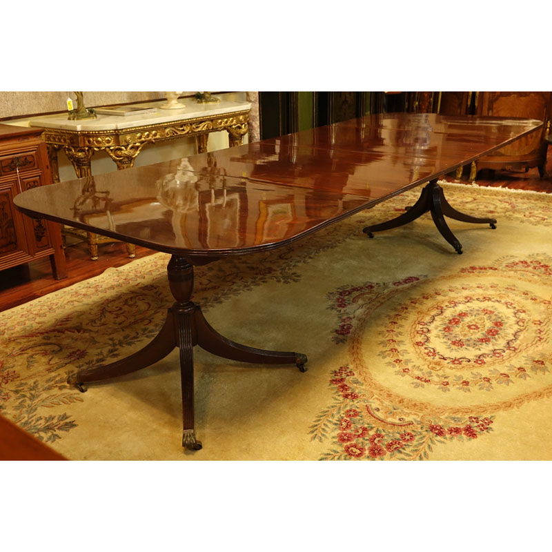 Large 19th Century Sheraton Mahogany Dinning Table. Carved urn pedestal with three sweeps and brass paw form terminals on Wheels.