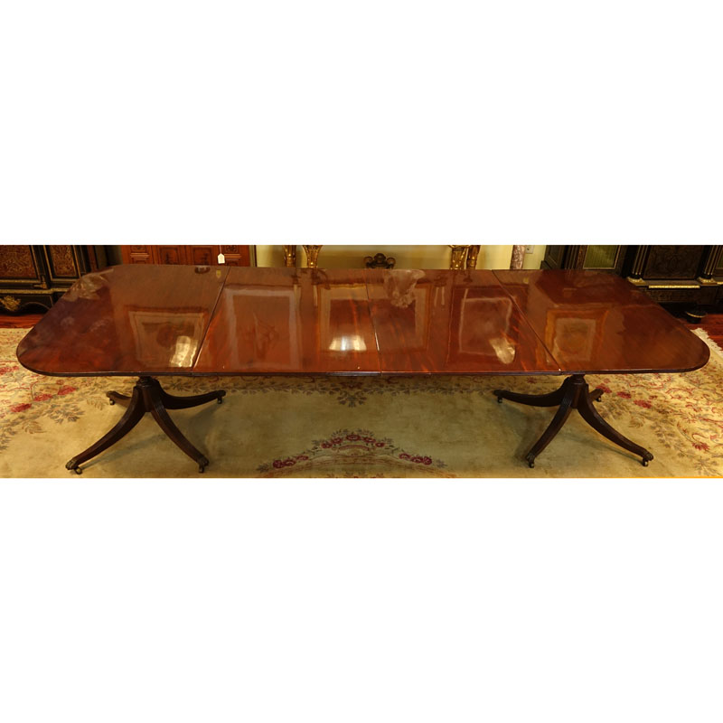 Large 19th Century Sheraton Mahogany Dinning Table. Carved urn pedestal with three sweeps and brass paw form terminals on Wheels.