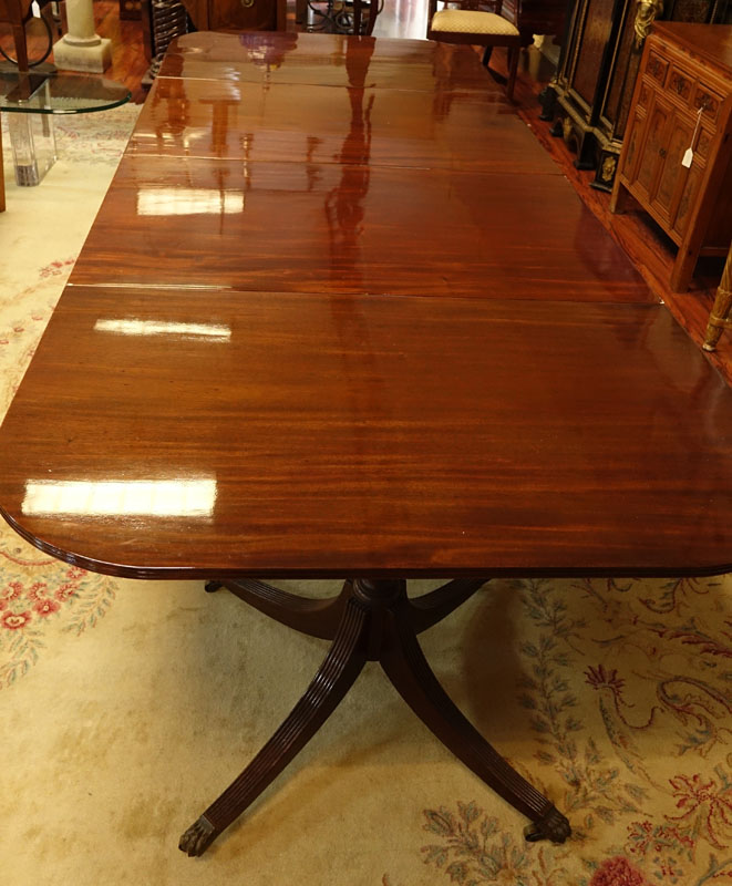 Large 19th Century Sheraton Mahogany Dinning Table. Carved urn pedestal with three sweeps and brass paw form terminals on Wheels.