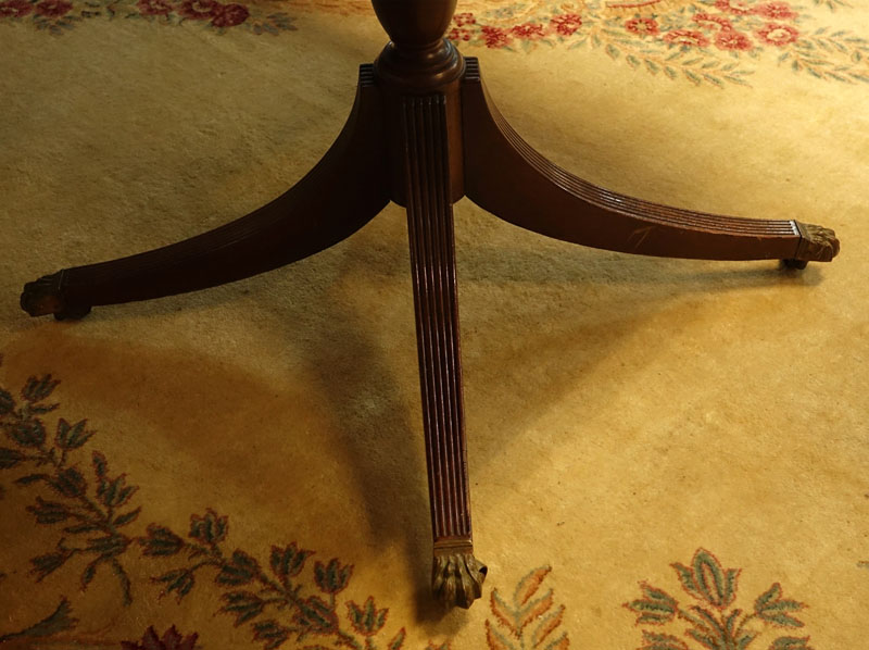 Large 19th Century Sheraton Mahogany Dinning Table. Carved urn pedestal with three sweeps and brass paw form terminals on Wheels.