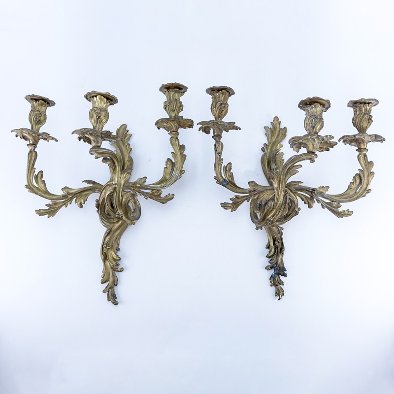 Pair of French Louis XV/Rococo Style Three Arm Gilt Bronze Wall Sconces. One has been professionally restored, rubbing to gilt.