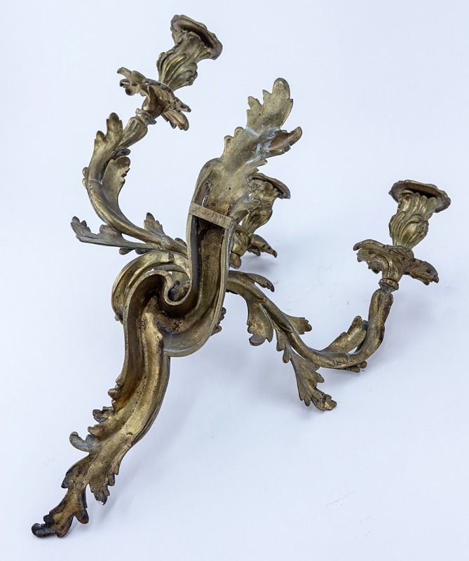 Pair of French Louis XV/Rococo Style Three Arm Gilt Bronze Wall Sconces. One has been professionally restored, rubbing to gilt.
