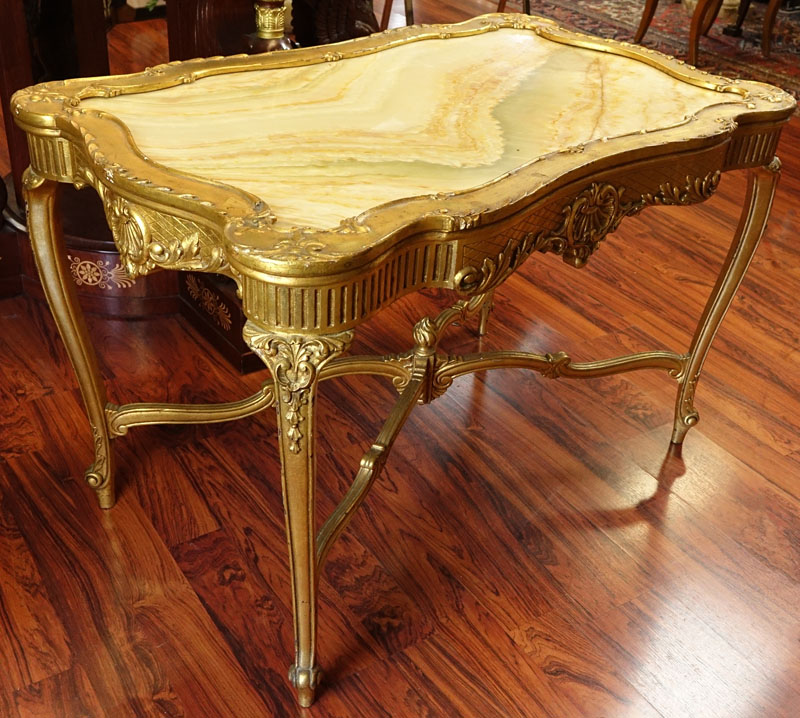 Early 20th Century Carved and Gilt Wood Center Table with Onyx Top.