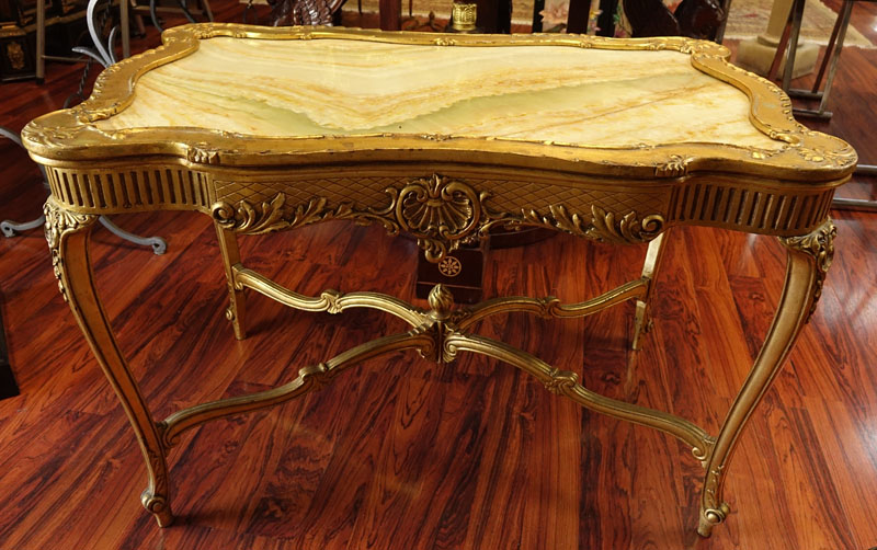 Early 20th Century Carved and Gilt Wood Center Table with Onyx Top.