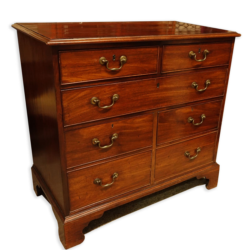 Antique Georgian Mahogany Chest of Drawers. Large fitted center drawer, two deep drawers lower, two fitted drawers with brass pulls, raised on shaped bracket feet. 