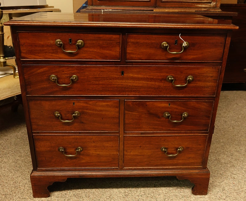 Antique Georgian Mahogany Chest of Drawers. Large fitted center drawer, two deep drawers lower, two fitted drawers with brass pulls, raised on shaped bracket feet. 