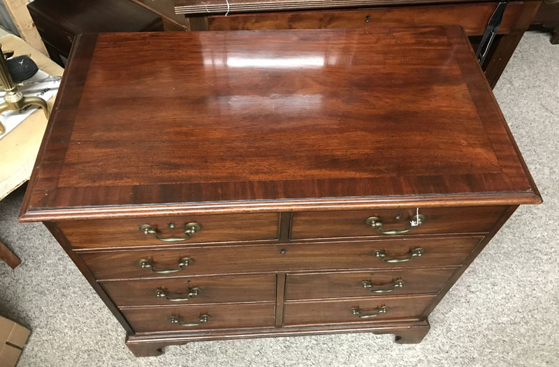 Antique Georgian Mahogany Chest of Drawers. Large fitted center drawer, two deep drawers lower, two fitted drawers with brass pulls, raised on shaped bracket feet. 