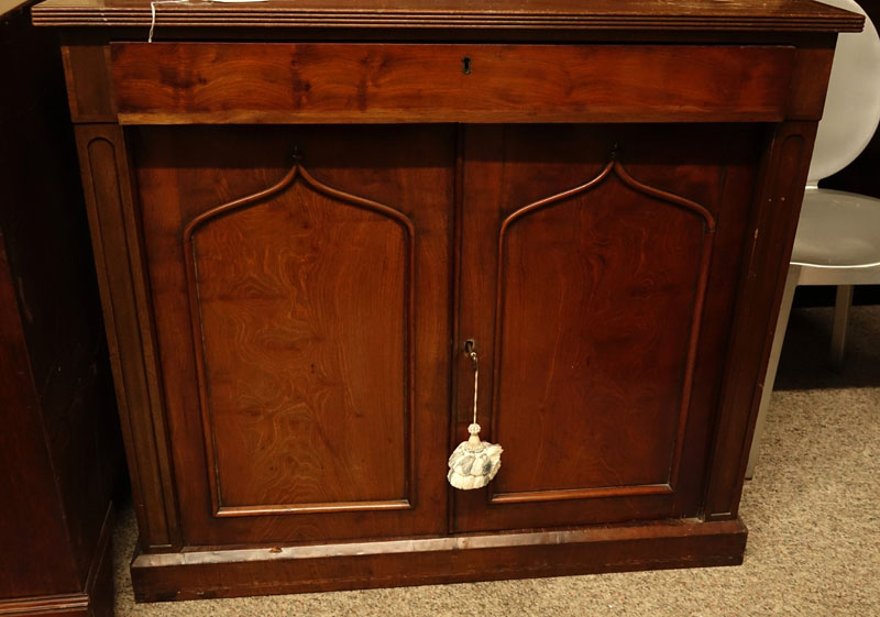 Antique Victorian Mahogany Bookcase. Two large glass display doors with gothic arches at the top, large fitted center drawer above two doors, key included.