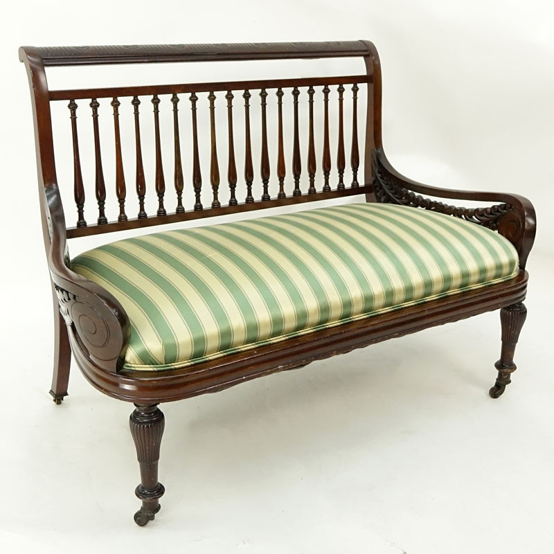 Mid Century Carved Wood and Upholstered Bench on Wheels.