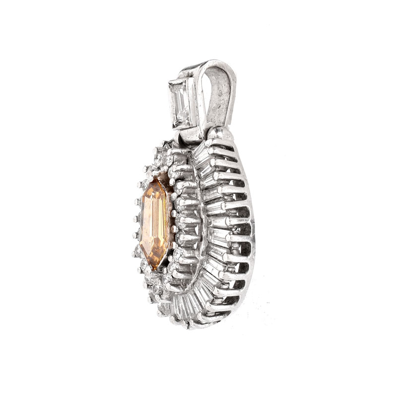 Vintage Approx. 1.35 Carat Fancy Yellow Brown Diamond and 18 Karat White Gold Pendant accented throughout with Baguette and Round Brilliant Cut Diamonds.