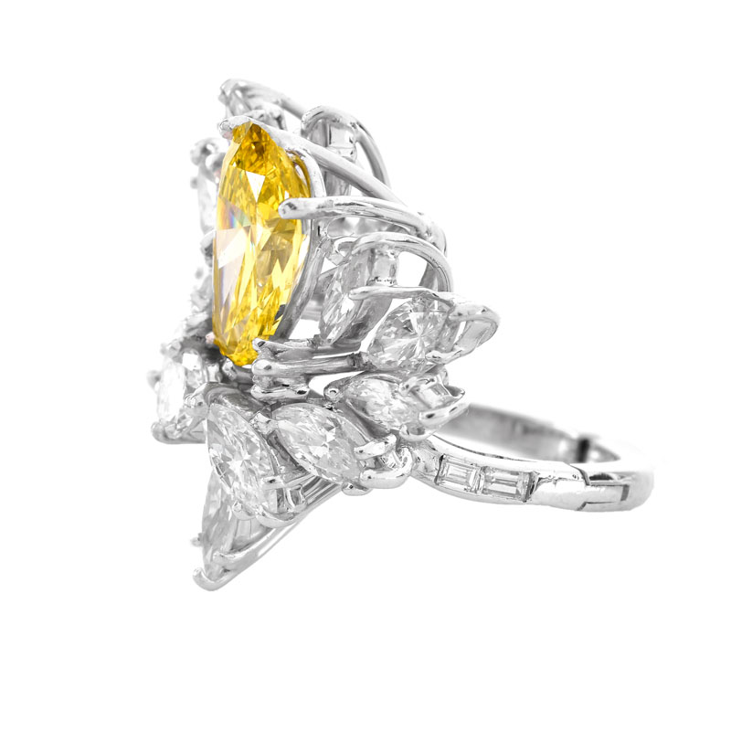 Vintage Circa 1960s Approx. 3.0 Carat Pear Shape Fancy Intense Yellow Diamond, 4.75 Carat Marquise, Round Brilliant and Baguette Cut Diamond and Platinum Ring.