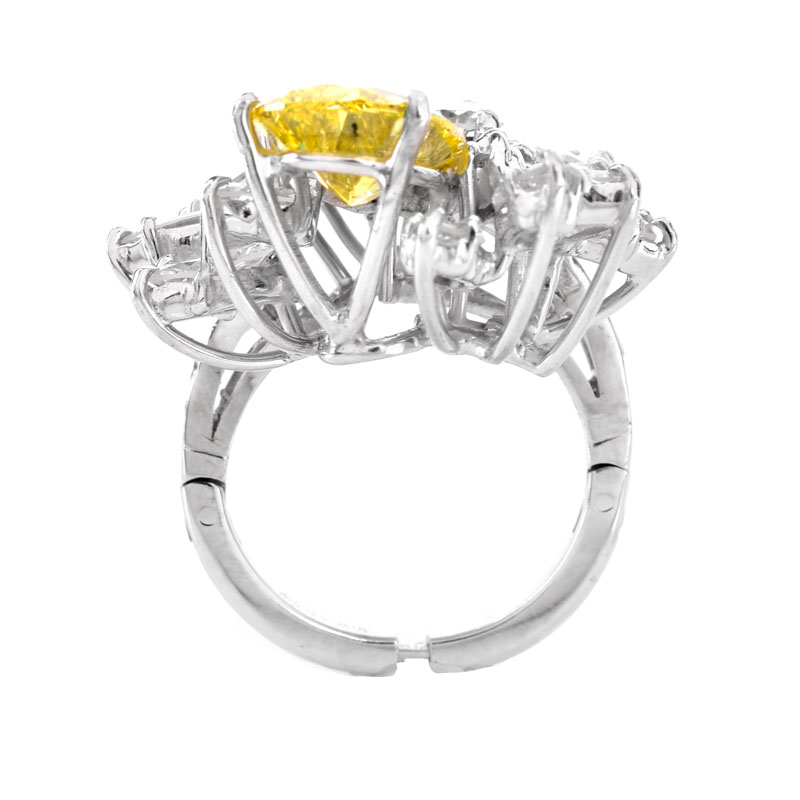 Vintage Circa 1960s Approx. 3.0 Carat Pear Shape Fancy Intense Yellow Diamond, 4.75 Carat Marquise, Round Brilliant and Baguette Cut Diamond and Platinum Ring.