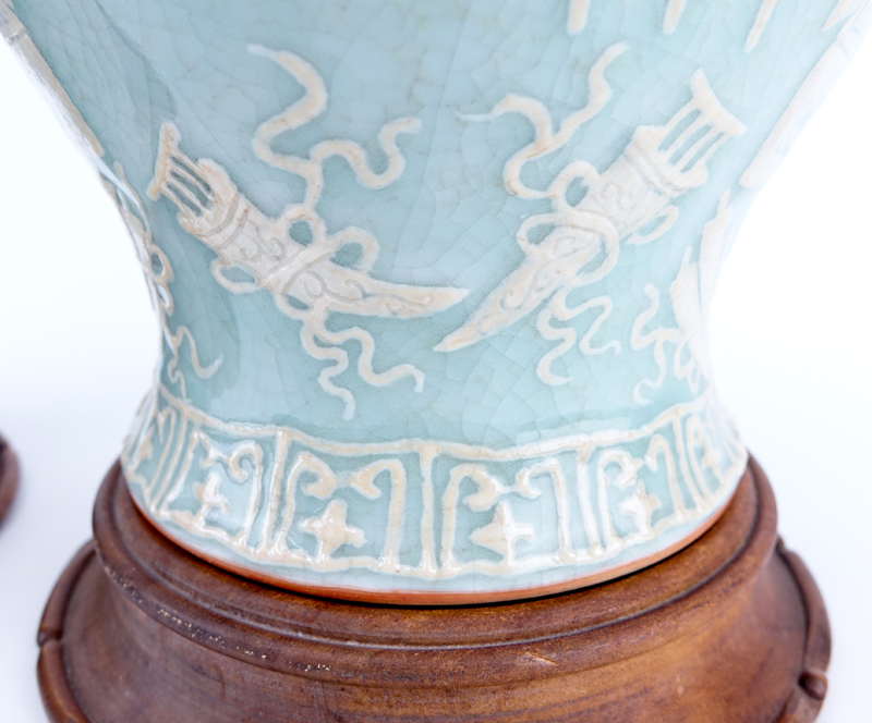 Pair of early to Mid 20th Century Chinese Celadon Glaze Porcelain Covered Jars on Wooden Stands. Unsigned.