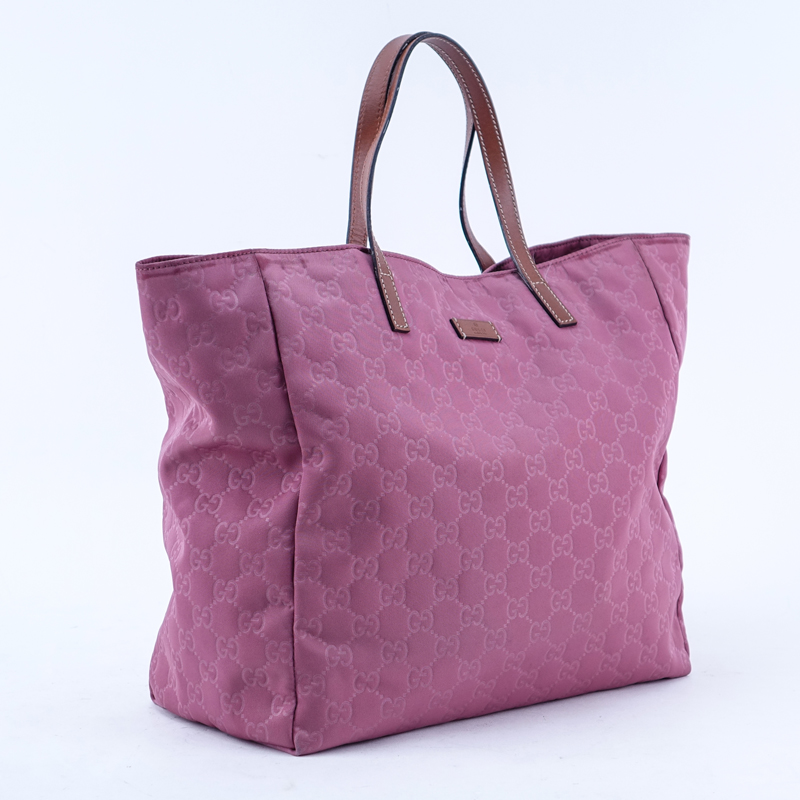 Gucci Pink Canvas Monogram Canvas Guccissima Tote. Brown leather straps. Natural canvas interior with zippered pocket.