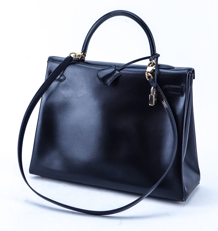 Hermes Black Kelly Retourne 35 Smooth Calf Leather Bag. Gold tone hardware. Leather interior with zipper pocket.