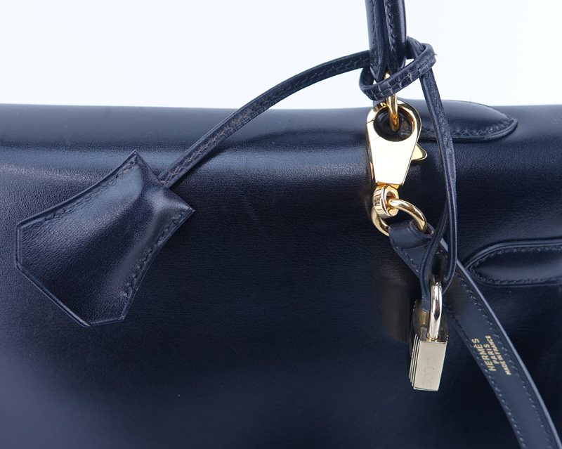 Hermes Black Kelly Retourne 35 Smooth Calf Leather Bag. Gold tone hardware. Leather interior with zipper pocket.