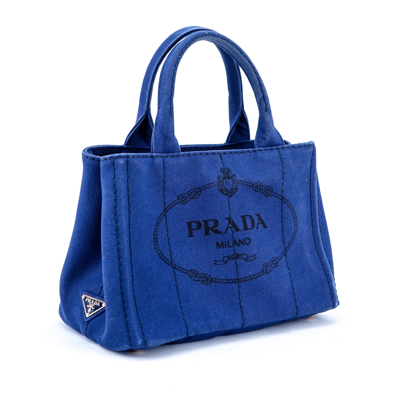 Prada Blue Canvas Denim Tote PM. Gold tone hardware. Interior of canvas with one zippered pocket and a slot pocket.