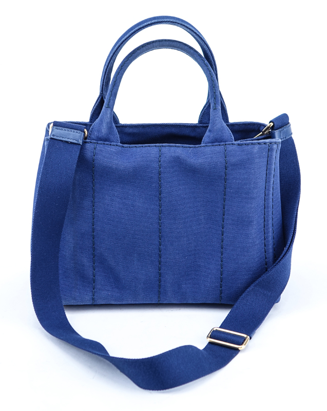 Prada Blue Canvas Denim Tote PM. Gold tone hardware. Interior of canvas with one zippered pocket and a slot pocket.