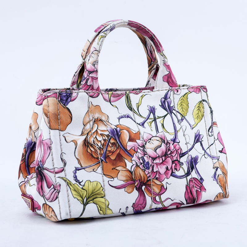 Prada Multi-Colored Floral Motif Canvas Canapa Mini Tote. Gold tone hardware, interior of pink canvas with zippered and patch pockets.