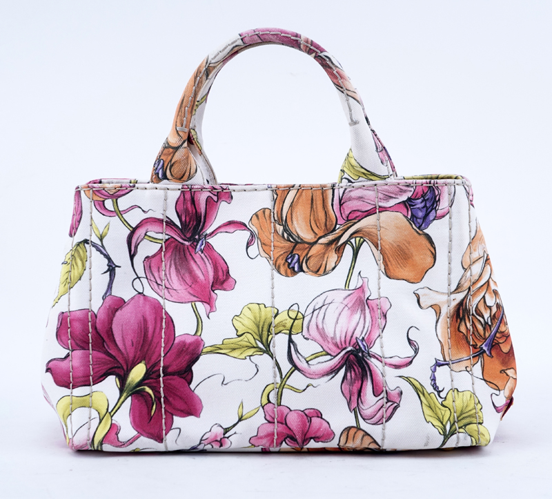 Prada Multi-Colored Floral Motif Canvas Canapa Mini Tote. Gold tone hardware, interior of pink canvas with zippered and patch pockets.