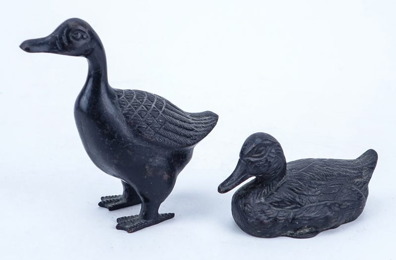 Lot of Eight (8) Patinated Bronze Duck Figures.