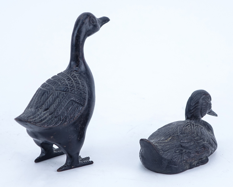 Lot of Eight (8) Patinated Bronze Duck Figures.