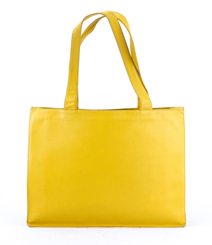 Chanel Yellow Caviar Leather Vintage Tote With Front Logo. Gold tone hardware. Interior with large zipper pocket.