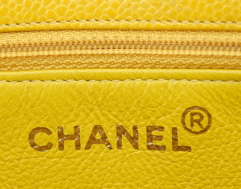 Chanel Yellow Caviar Leather Vintage Tote With Front Logo. Gold tone hardware. Interior with large zipper pocket.