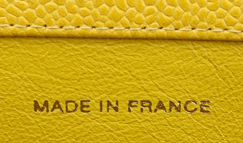 Chanel Yellow Caviar Leather Vintage Tote With Front Logo. Gold tone hardware. Interior with large zipper pocket.