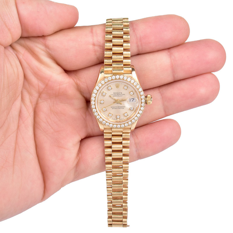 Lady's Rolex Presidential 18 Karat Yellow Gold Bracelet Watch with Factory Diamond Bezel and Hour Makers.