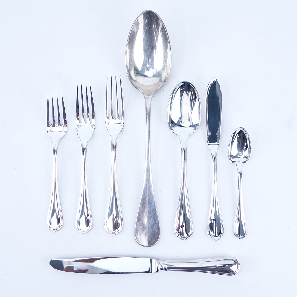 Eighty Five (85) Piece Christofle "Spatours" Silver Plate Flatware with Associated Serving Spoon. Includes: 12 knives 9", 12 forks 7-1/2", 12 salad forks, 12 fish forks 7", 12 spoons 7-1/2", 12 teaspoons, and 12 butter spreaders, large serving spoon 11".