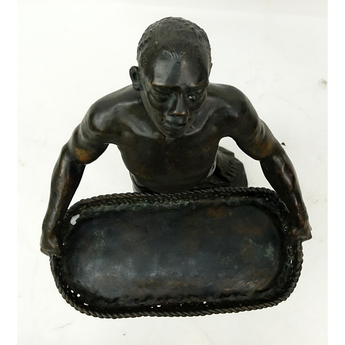 A Patinated Bronze Sculpture, Nubian Male Carrying Basket, Unsigned. Rubbing to surface overall good condition.