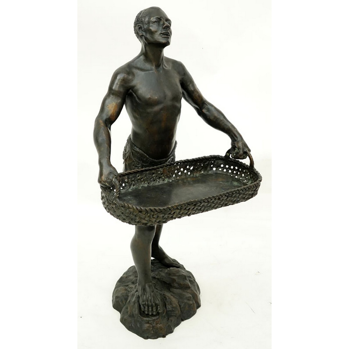 A Patinated Bronze Sculpture, Nubian Male Carrying Basket, Unsigned. Rubbing to surface overall good condition.