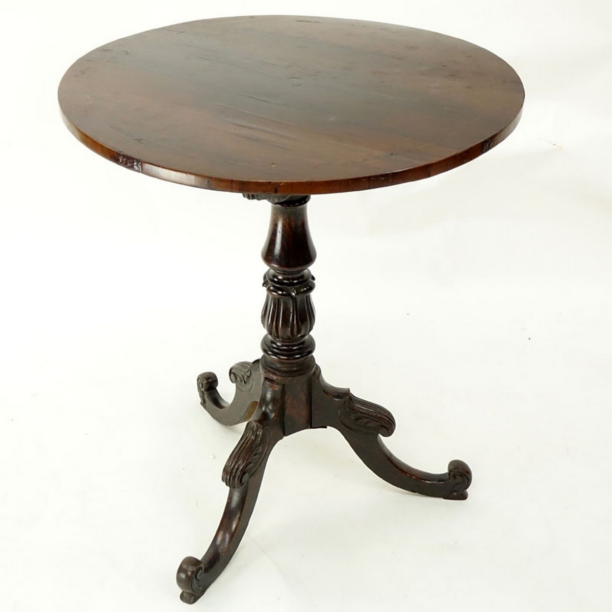 Queen Anne Mahogany Round Tilt Top Table. Carved baluster form stem standing on tri pod feet.