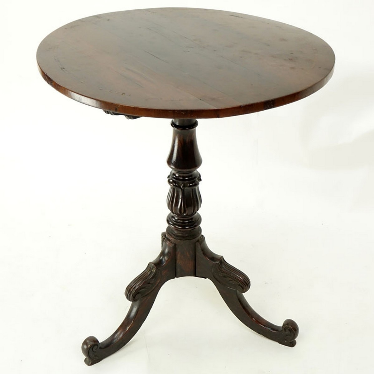 Queen Anne Mahogany Round Tilt Top Table. Carved baluster form stem standing on tri pod feet.