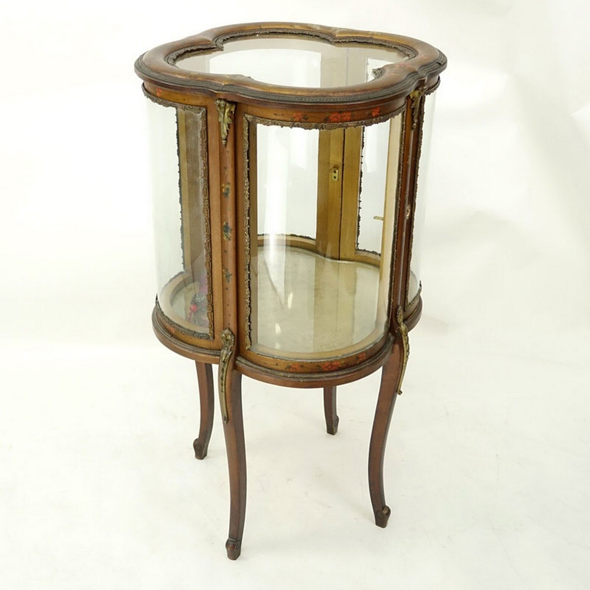 20th Century French Gilt and Floral Painted Vitrine with Brass Fittings. Two large curved fitted doors with single glass shelve, key included.