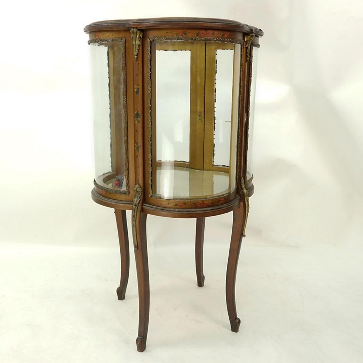 20th Century French Gilt and Floral Painted Vitrine with Brass Fittings. Two large curved fitted doors with single glass shelve, key included.