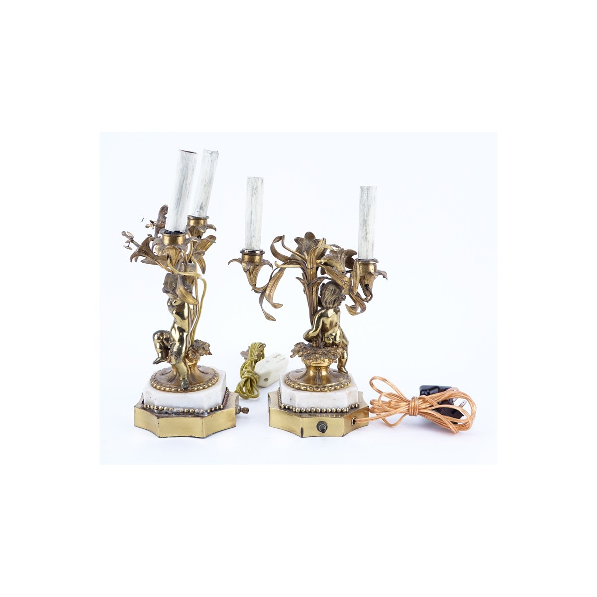 Pair of Gilt Brass Putti Two Light Electrified Candelabras. Each have been repaired, residue to surface, rubbing to gilt.