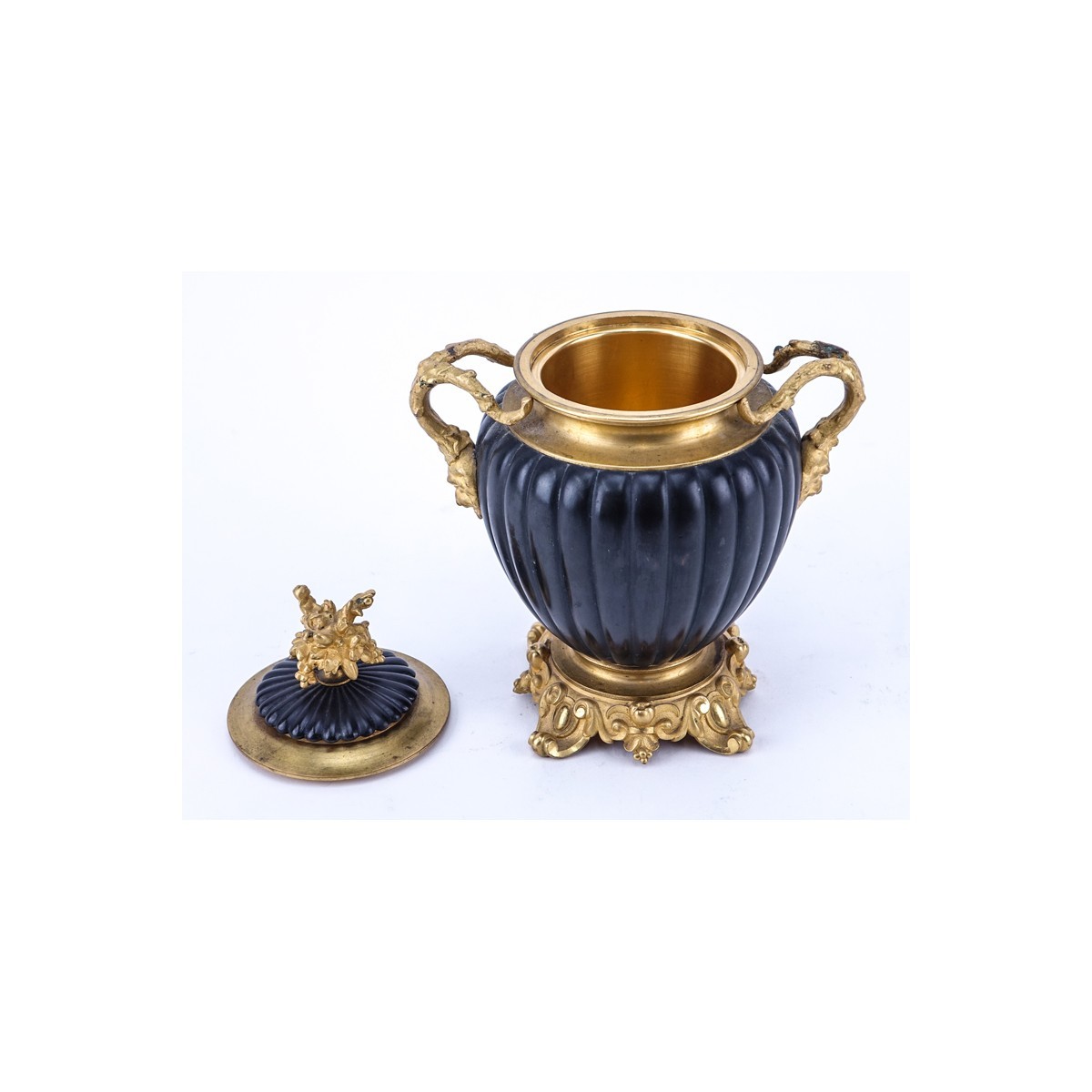 Neoclassical Style Gilt Brass and Painted Covered Urn with Bacchus Motif. Light rubbing to gilt overall good condition.
