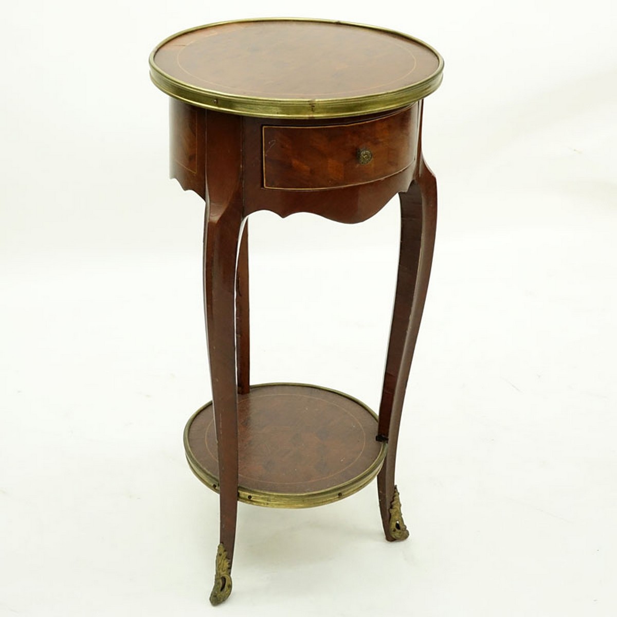 20th Century French Louis XVI Style Parquetry Inlaid Gilt Brass Round Side Table. Single fitted sliding drawer with shelf stretcher.