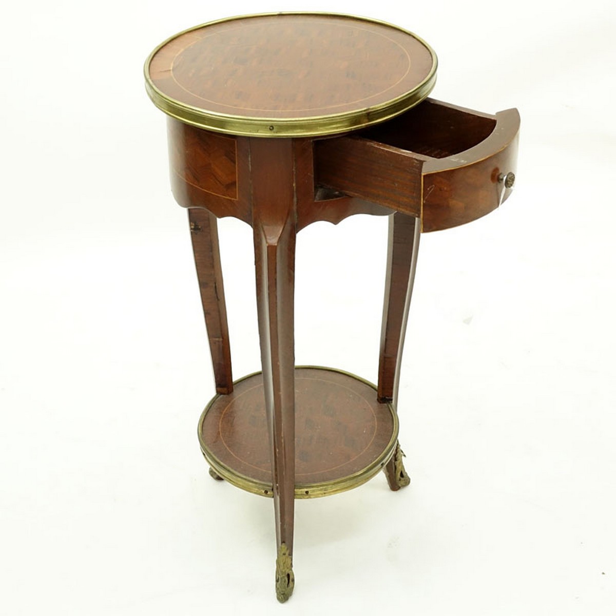 20th Century French Louis XVI Style Parquetry Inlaid Gilt Brass Round Side Table. Single fitted sliding drawer with shelf stretcher.