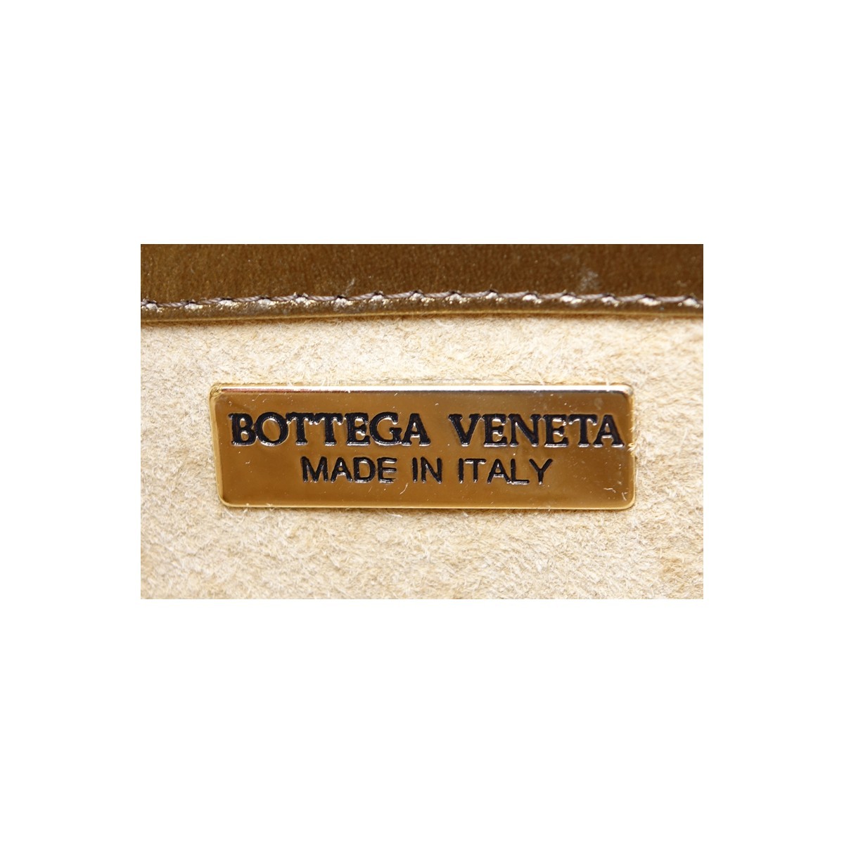 Bottega Veneta Gold Woven Shoulder Bag. Gold tone hardware, beige suede interior with zippered pocket.