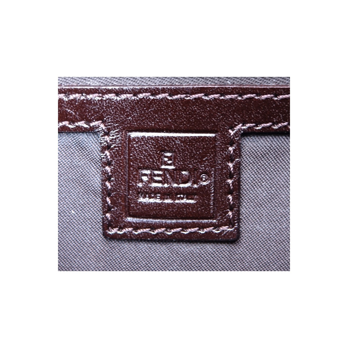 Fendi Brown Monogram Canvas Baguette Handbag. Silvertone hardware, interior of dark brown canvas with zippered pocket.