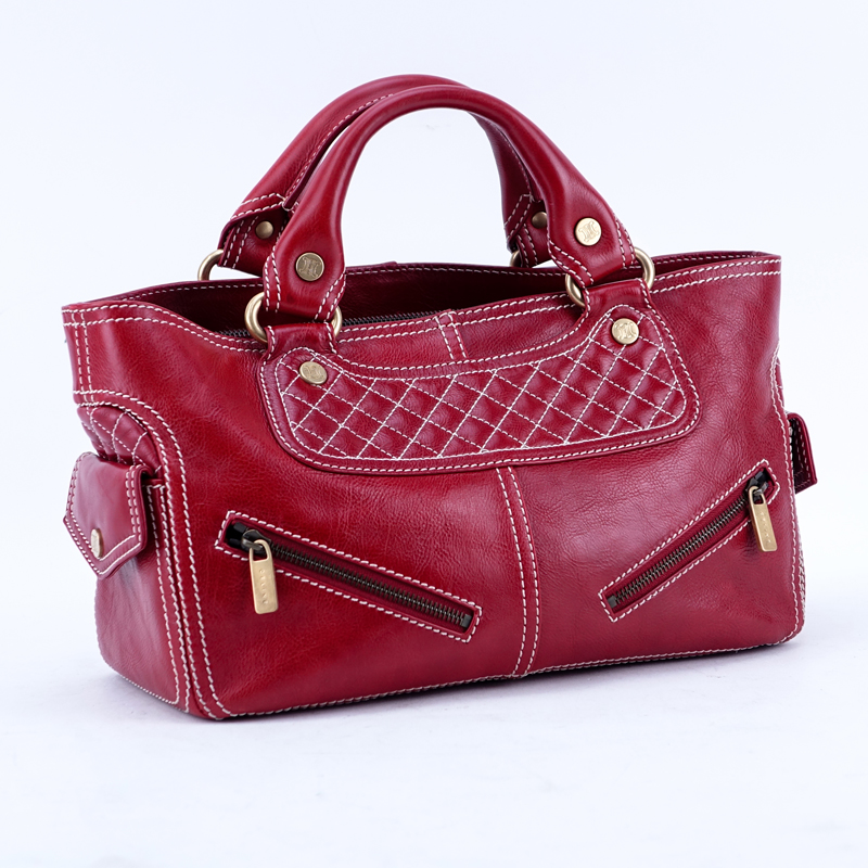 Celine Red Soft/Quilted Leather Boogie Bag With 2 Front Pockets. Brushed gold tone hardware, black canvas interior with zippered and patch pockets.