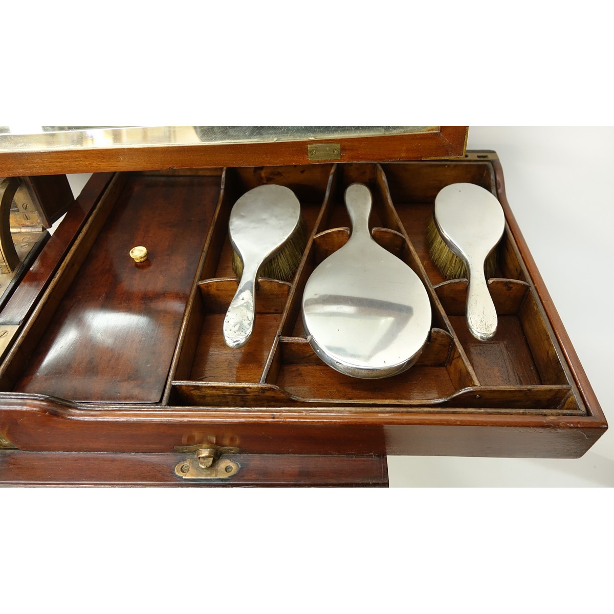 Attributed to: George Betjeman & Sons Circa 1910 Edwardian Mahogany Enclosed Dressing Table. The rectangular hinged top enclosing an interior fitted with three beveled mirror plates, above two hinged compartments flanked by two glass slides and a recessed