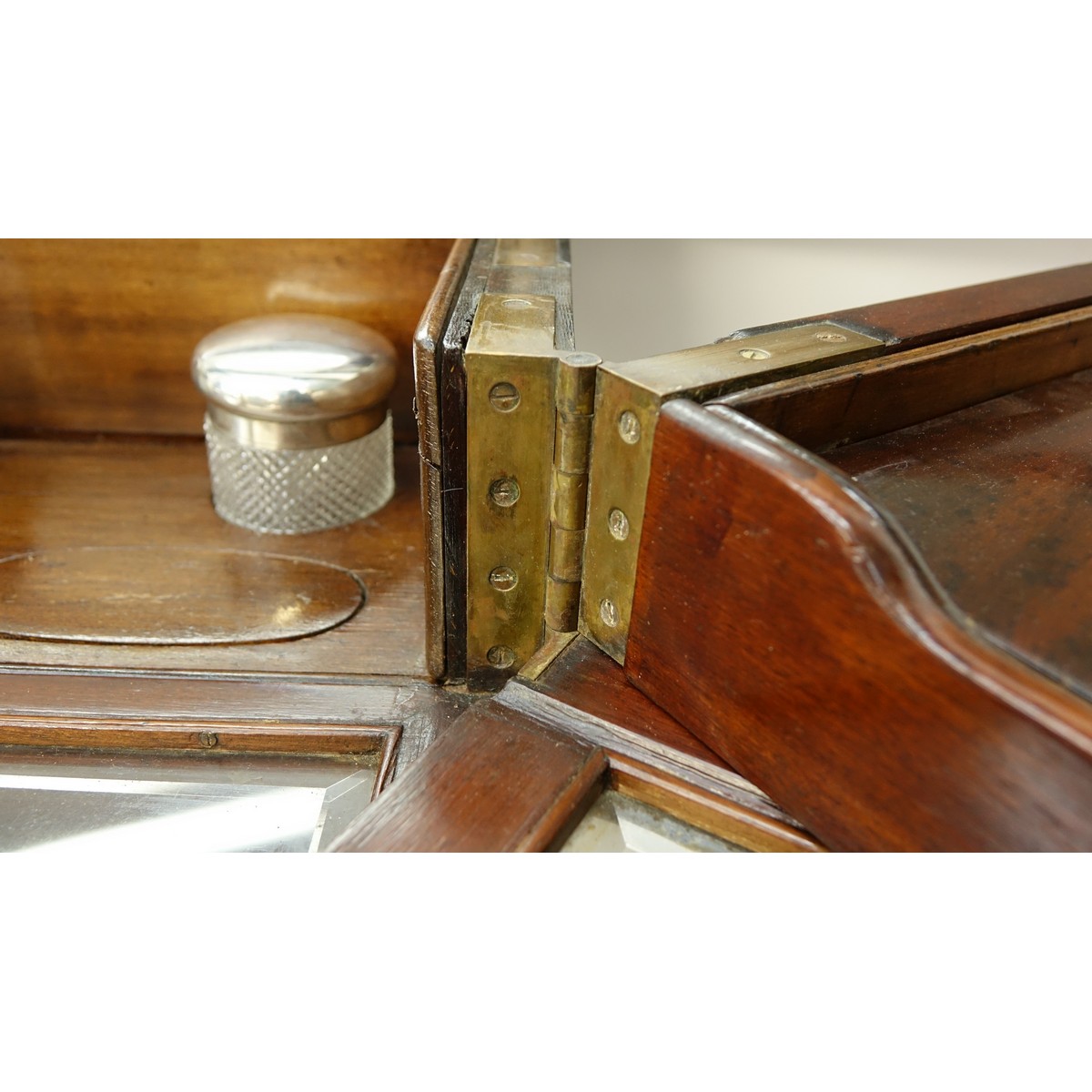 Attributed to: George Betjeman & Sons Circa 1910 Edwardian Mahogany Enclosed Dressing Table. The rectangular hinged top enclosing an interior fitted with three beveled mirror plates, above two hinged compartments flanked by two glass slides and a recessed