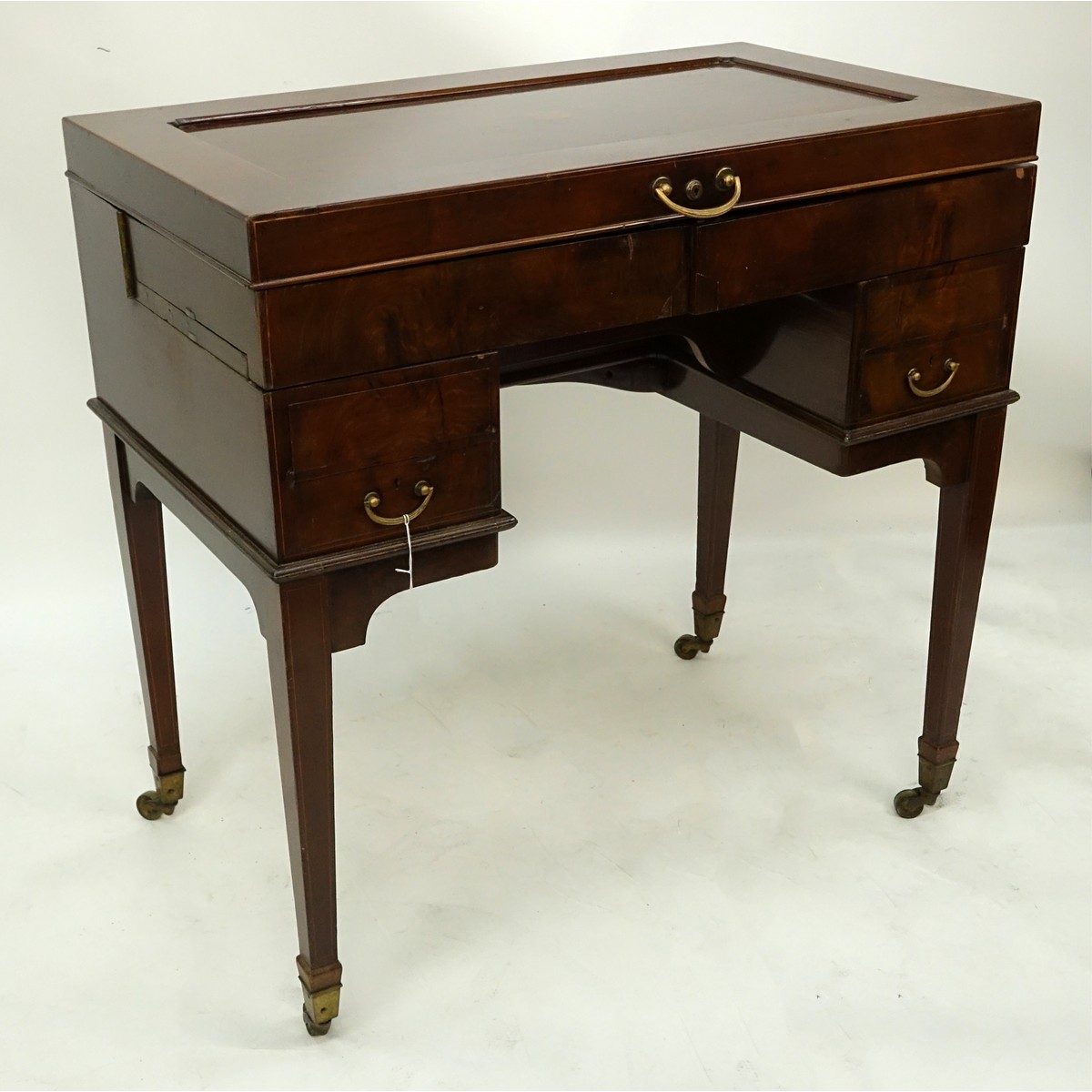 Attributed to: George Betjeman & Sons Circa 1910 Edwardian Mahogany Enclosed Dressing Table. The rectangular hinged top enclosing an interior fitted with three beveled mirror plates, above two hinged compartments flanked by two glass slides and a recessed