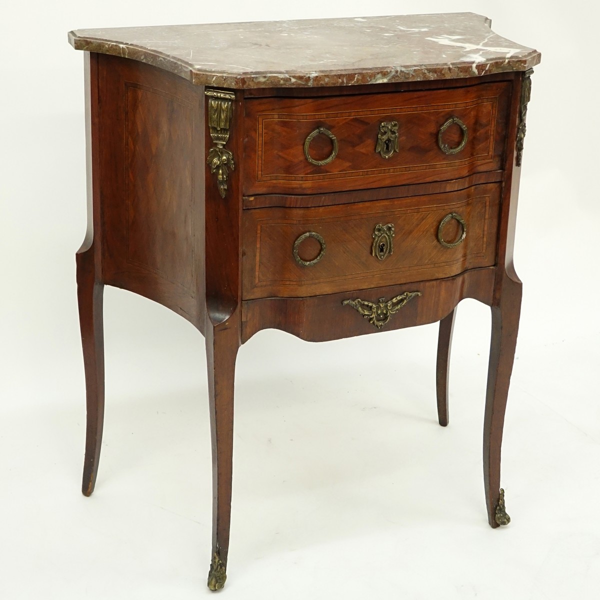 Early 20th Century Parquetry Inlaid Marble Top Commode with Bronze Mounts. Two drawers and stands on high cabriole legs.