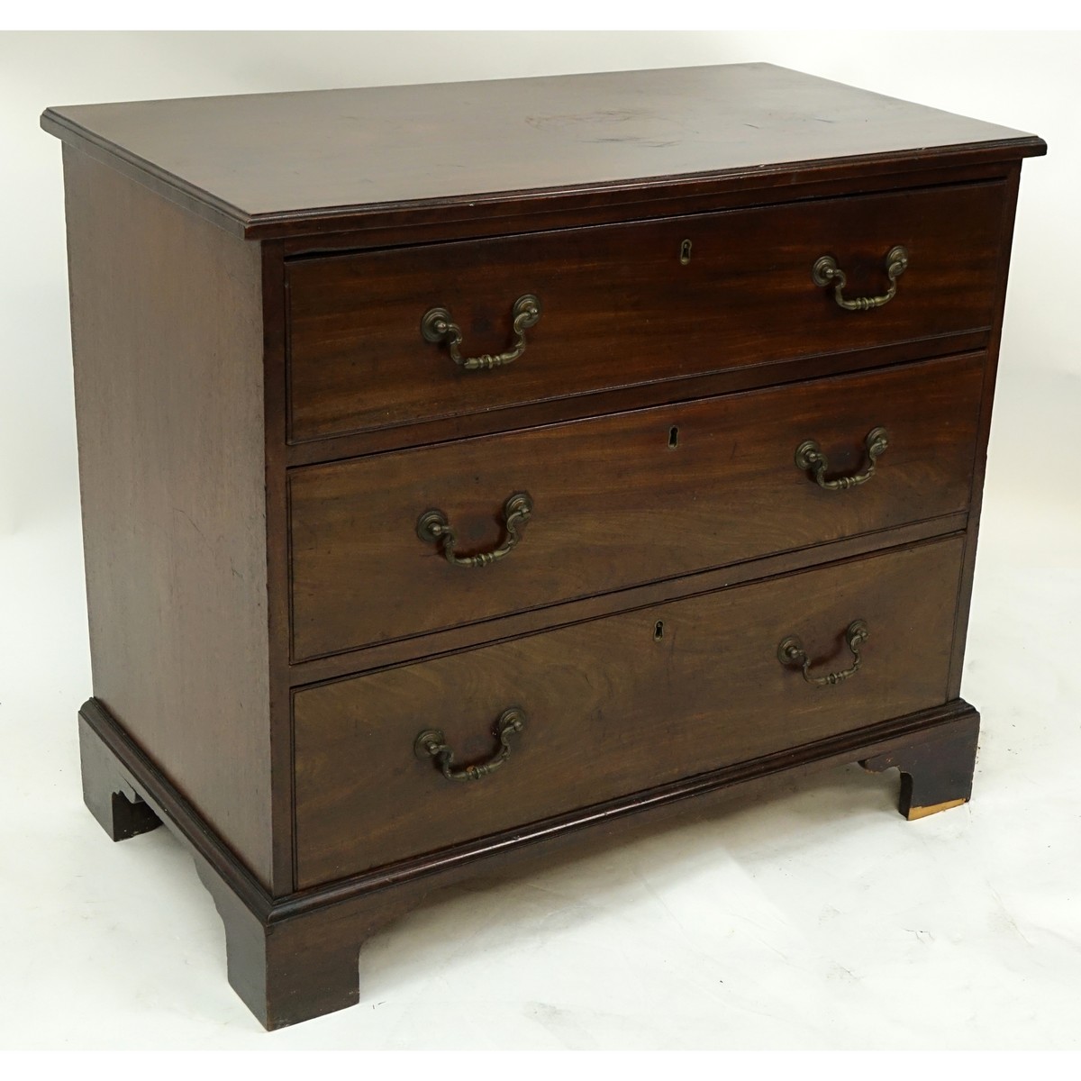 19th Century English Georgian Mahogany Chest of Drawers/Commode. Three large sliding drawers with bracket feet.