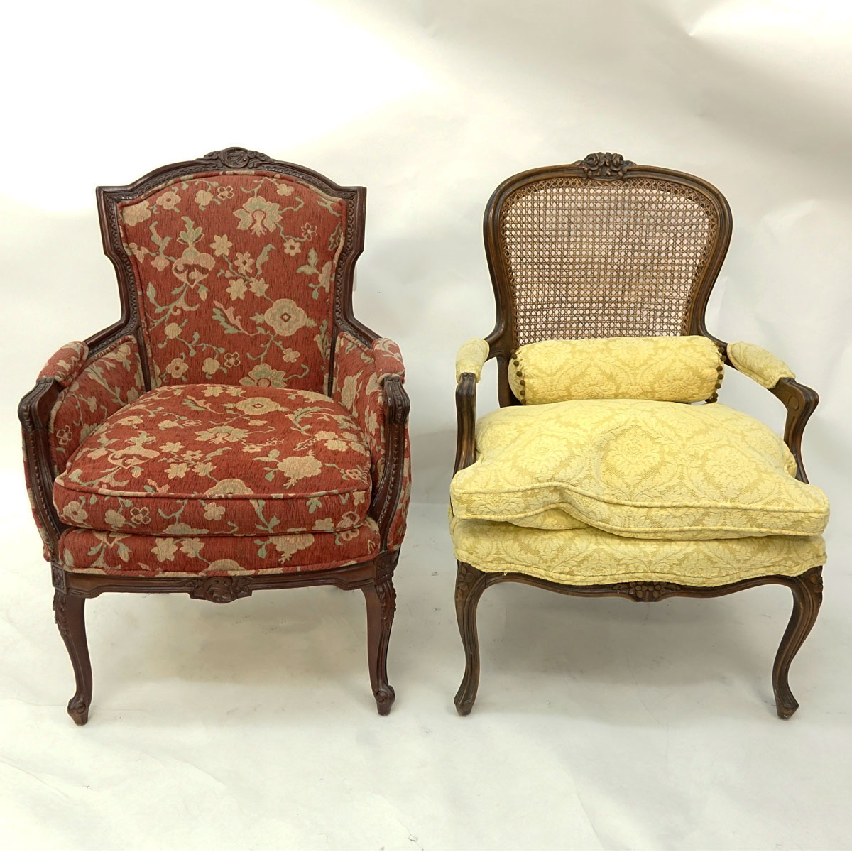 Two (2) 20th Century French Carved Louis XV style Chairs, Fauteuil with Cane Back and Bergere. Unsigned.